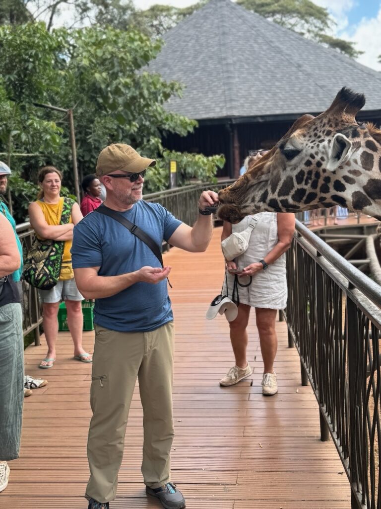 Trey feeding giraffe at the giraffe center